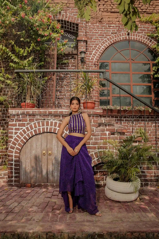 Full-length front view of the Aaroohi purple georgette draped skirt set with a mirror-work halter blouse, ideal for Indian wedding guest wear.