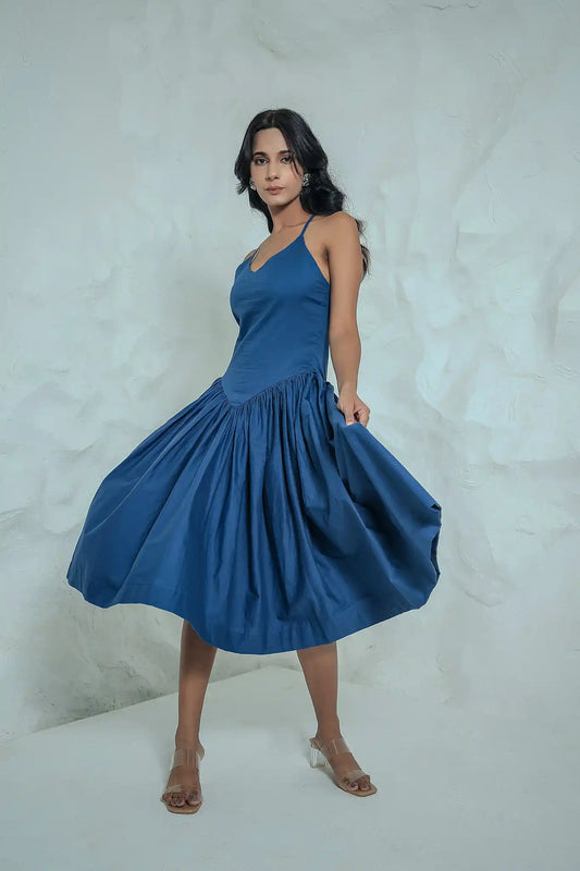 Full-length front view of a model styling the sleeveless midnight blue cotton lycra maxi dress.