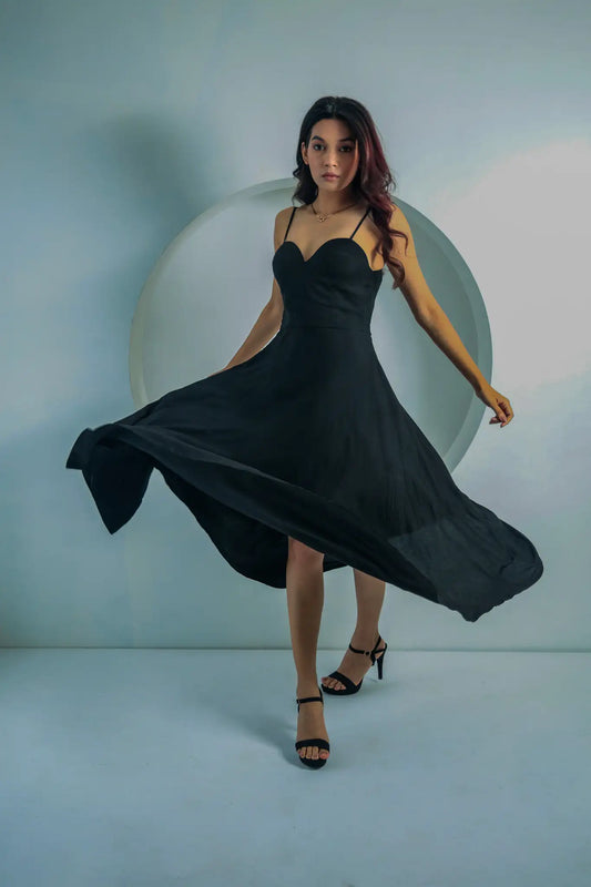 Flowing front view of the Tea & Dove Black Twilight Embrace midi flare dress in soft Tencel fabric for evening wear.