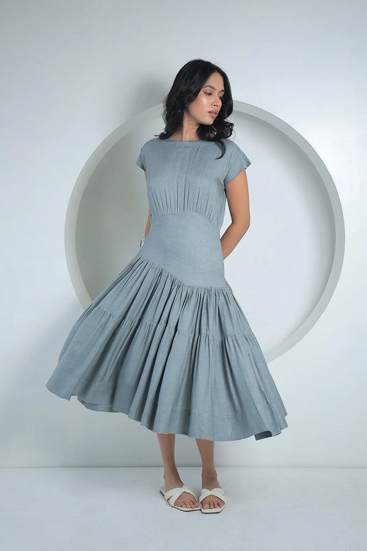 Dynamic motion shot highlighting the flared tiered skirt of the grey Serene Twill Midi Dress.