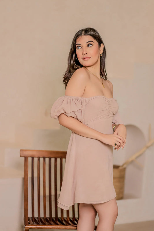 Side profile view of a model wearing the mushroom brown off-the-shoulder puff sleeve Summer Whisper Short Dress.